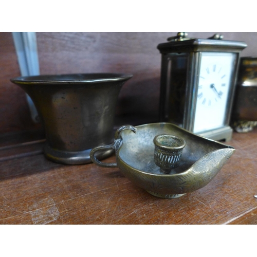 657 - A bronze mortar, brass carriage clock and two other brass items