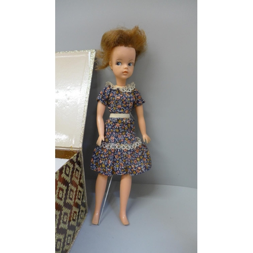 668 - A 1963 Sindy (England) and Space Fantasy Sindy with box of various doll stands