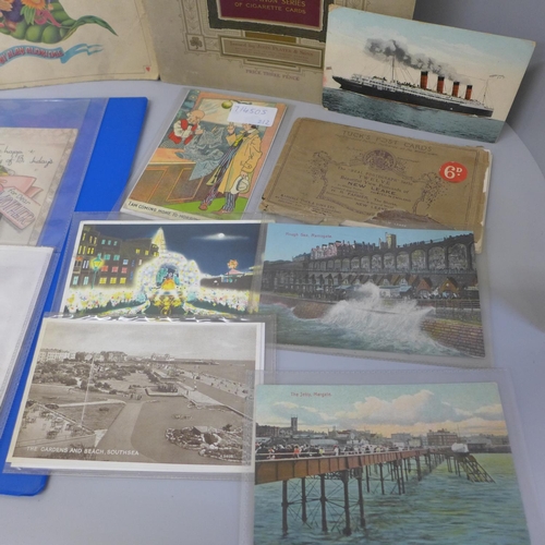 702 - A collection of postcards and cigarette cards and a Beatles illustrated lyrics book