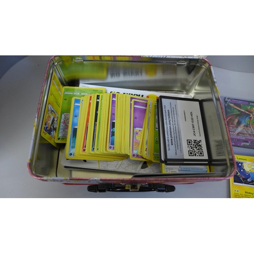 731 - Pokemon cards; a Pokemon collectors tin containing 300 basic Pokemon cards, one full art card in har... 