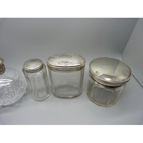 874 - Four vintage silver topped jars and a cut glass perfume bottle