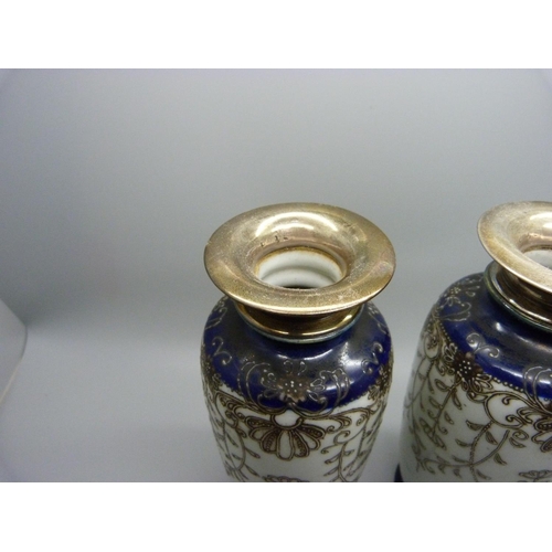 876 - A pair of silver topped Japanese vases, Birmingham 1945 hallmark