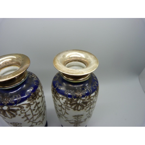 876 - A pair of silver topped Japanese vases, Birmingham 1945 hallmark