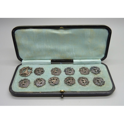 883 - A set of eleven silver buttons, Birmingham 1901, and one similar larger silver buttons, 23g