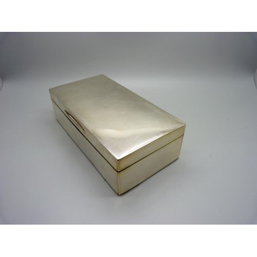 884 - A silver cigarette box with cedar lining, 528g gross