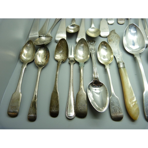 888 - A collection of silver flatware, 1302g