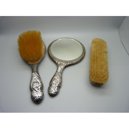 893 - A silver three piece vanity set, decorated with Reynolds Angels, Birmingham 1907