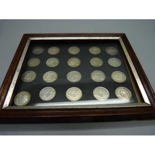 900 - A framed set of twenty silver threepence coins