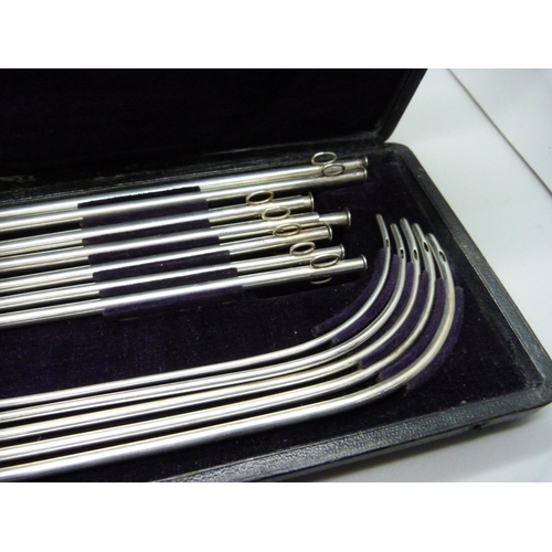 908 - A cased set of white metal medical/surgical instruments