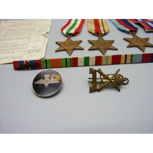 909 - Four WWII medals, a sharp-shooter's badge, RAF badge and medal bar