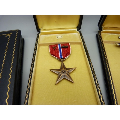 911 - A bronze star medal and two empty purple heart medal cases