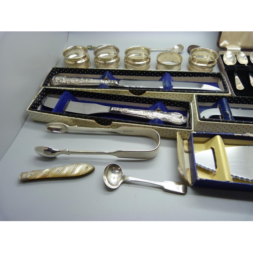 929 - Five silver handled knives, a cased set of six silver spoons, five silver napkin rings, silver sugar... 