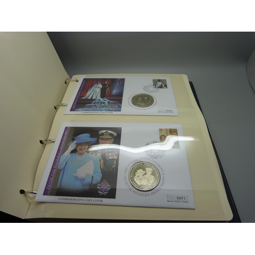 954 - An album of coin covers and a cased set of four The Queen Elizabeth II photographic £5 coin collecti... 