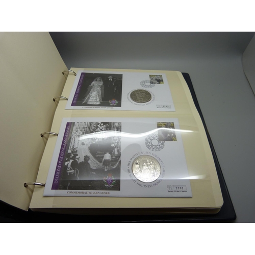 954 - An album of coin covers and a cased set of four The Queen Elizabeth II photographic £5 coin collecti... 