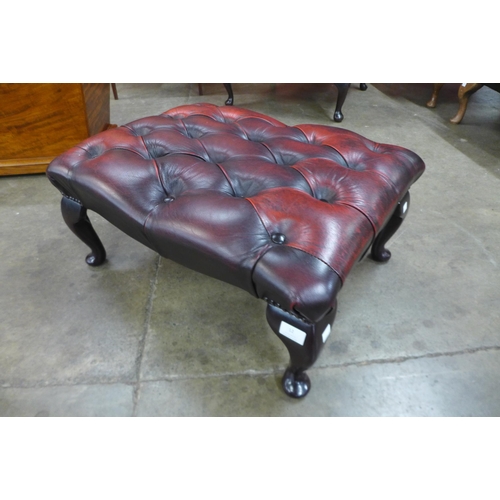 12 - A red leather Chesterfield footstool