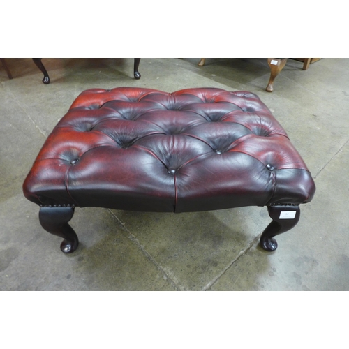 12 - A red leather Chesterfield footstool