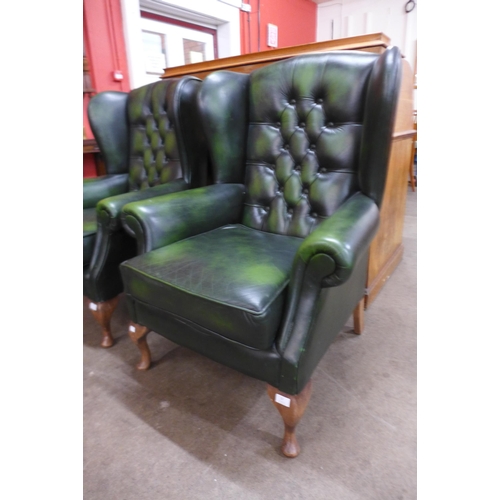 13 - A green leather Chesterfield wingback armchair