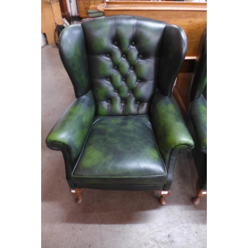 14 - A green leather Chesterfield wingback armchair