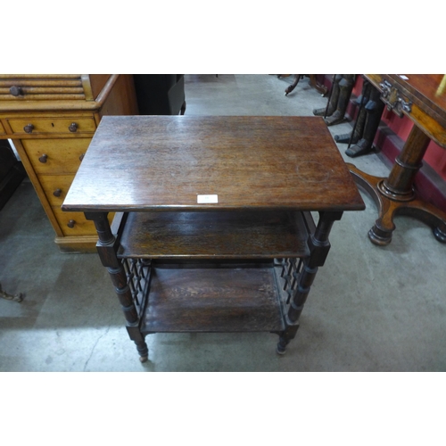 16 - A Liberty & Co. Arts and Crafts oak three tier bookstand, designed by Leonard Wyburd