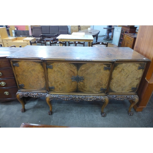 168 - An early 20th Century Queen Anne style carved burr walnut breakfront sideboard, retailed by Harrods,... 