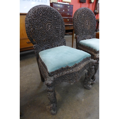 18 - A pair of Anglo Indian carved padouk wood chairs