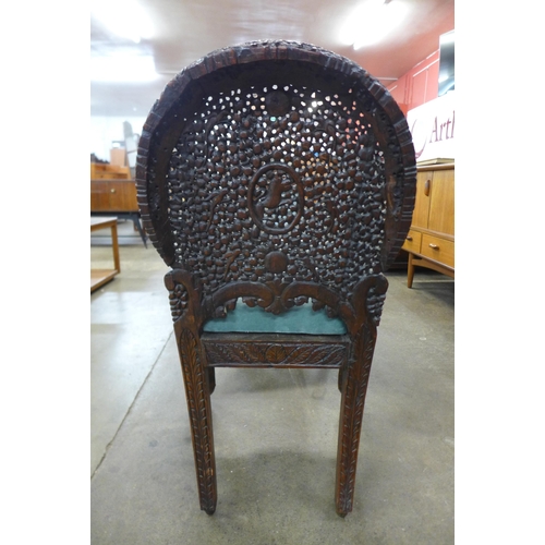 18 - A pair of Anglo Indian carved padouk wood chairs