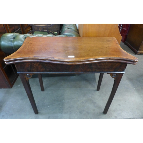 22 - A George III mahogany serpentine fold over tea table