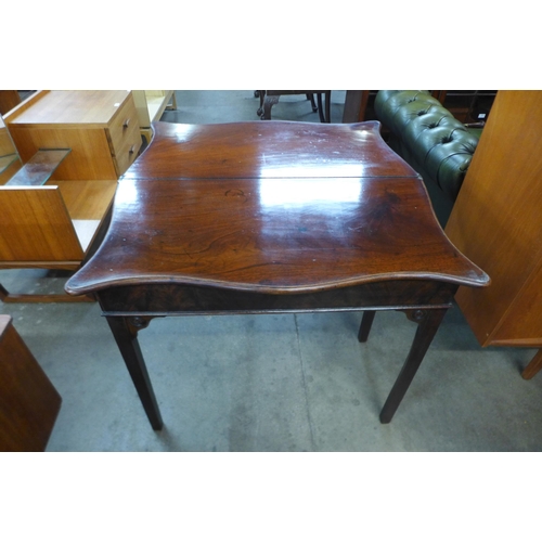 22 - A George III mahogany serpentine fold over tea table