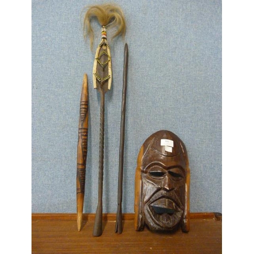 366 - A tribal spear and a wooden wall hanging face mask