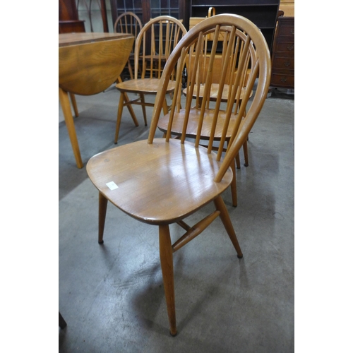 55 - A set of four Ercol Blonde elm and beech Windsor chairs