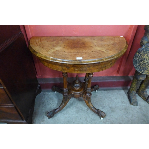 6 - A Victorian inlaid carved walnut demi lune games table