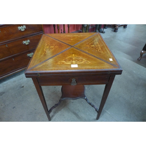 9 - An Edward VII inlaid mahogany envelope games table