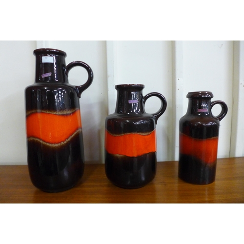 90 - A set three West German graduated Scheurich Keramik fat lava fabiola glazed pottery jugs, comprising... 