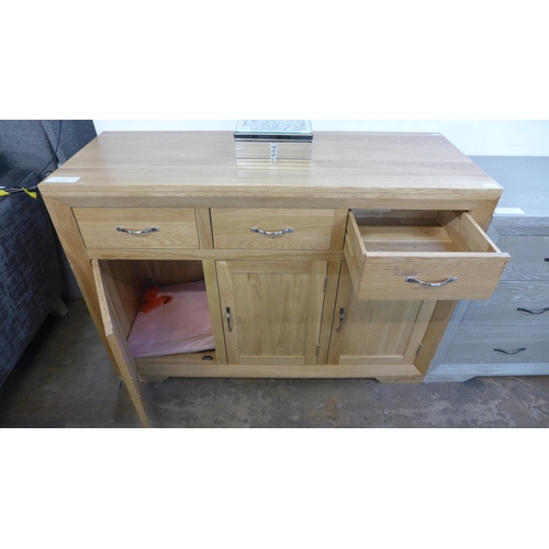 1425 - A Bevel natural oak three door, three drawer large sideboard * this lot is subject to VAT