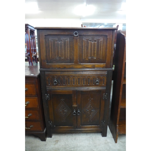 208 - A carved oak cocktail cabinet