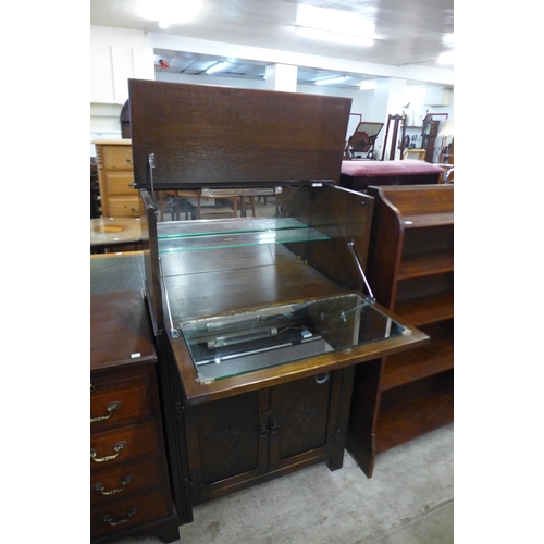 208 - A carved oak cocktail cabinet