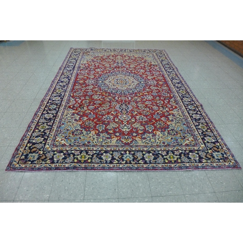 202A - A Persian red ground Isfahan rug, 350 x 243cms