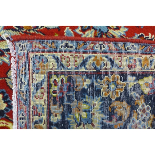 202A - A Persian red ground Isfahan rug, 350 x 243cms