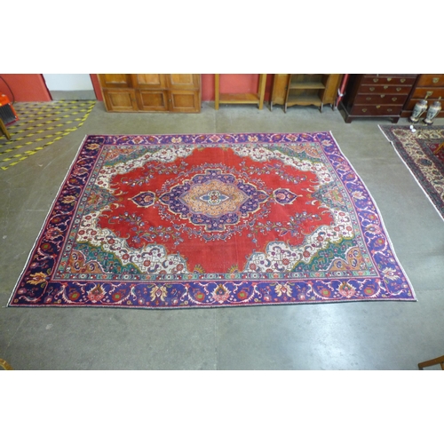 202B - A Persian red ground Tabriz rug, 368 x 279cms