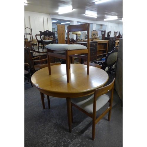 18 - A teak extending dining table and four chairs