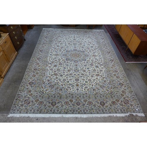 202 - A Persian cream ground Kashan rug, 408 x 300cms