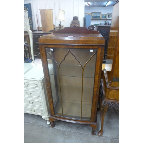 210 - A walnut bow front display cabinet