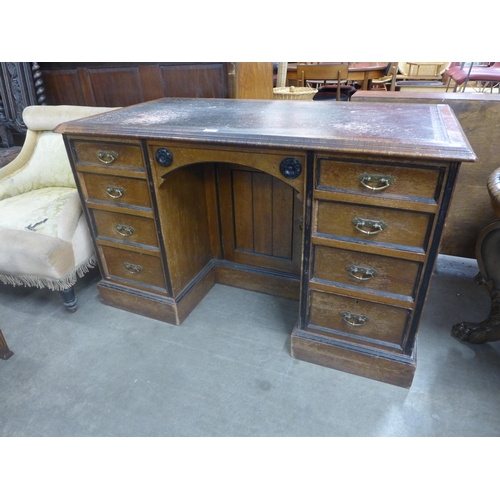 235 - A Victorian Aesthetic Movement oak kneehole desk