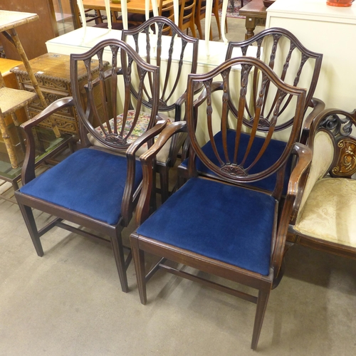 255 - A set of four Hepplewhite style mahogany elbow chairs