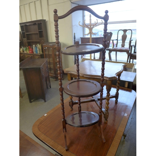 298 - A mahogany three tier folding cake stand, a/f