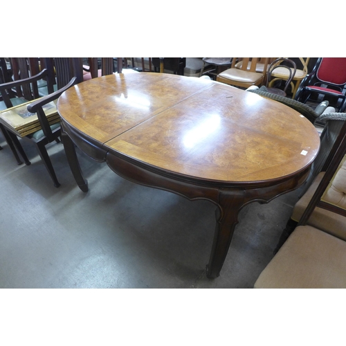 318 - A Chinese oval elm and walnut dining table