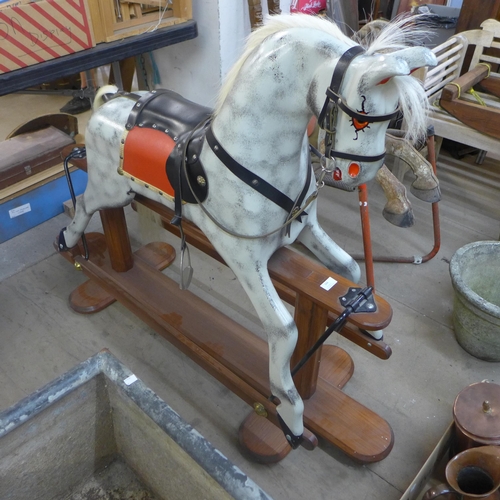 344 - A painted dapple grey child's rocking horse on stand