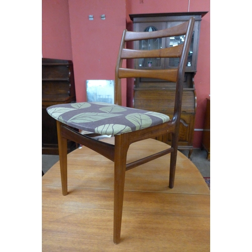 38 - A teak extending dining table and four chairs