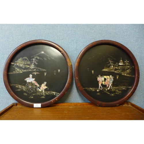 437 - A pair of Japanese export black lacquered circular wall plaques