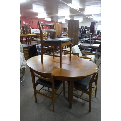 52 - A teak extending dining table and four chairs